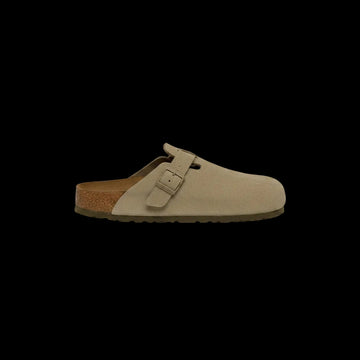 Beige suede clog shoe with a brown sole on a white background