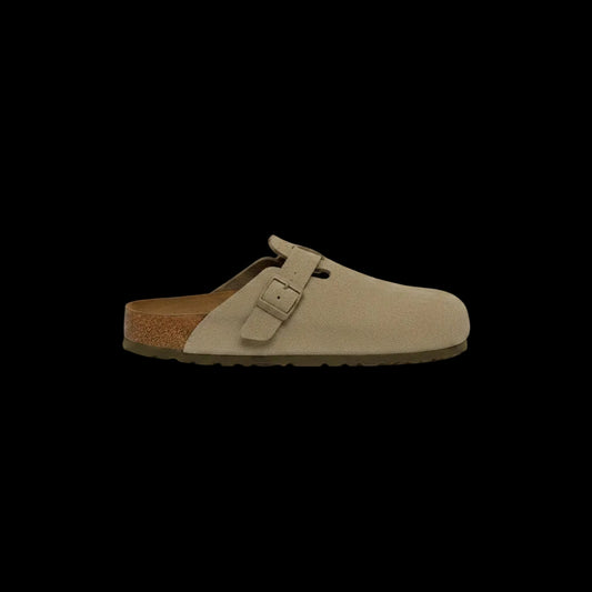 Beige suede clog shoe with a brown sole on a white background